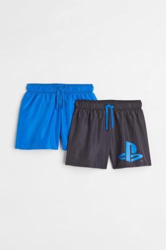 H&M 2er-Pack Badeshorts mit Print Knallblau/PlayStation in Größe 92. F...