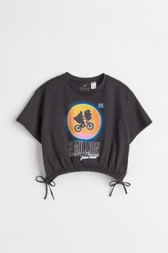 H&M T-Shirt mit Tunnelzug Schwarz/E.T., T-Shirts & Tops in Größe 158/1...