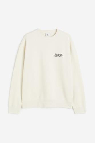 H&M Bedrucktes Sweatshirt in Loose Fit Cremefarben/Stones, Sweatshirts...