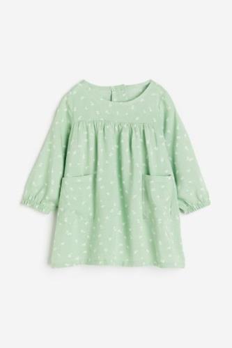 H&M Kleid mit Taschen Hellgrün/Geblümt, Kleider in Größe 80. Farbe: Li...