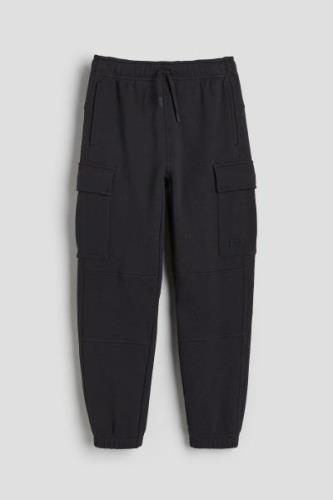 H&M DryMove™ Cargo-Joggpants aus Baumwolle Schwarz, Jogginghose in Grö...