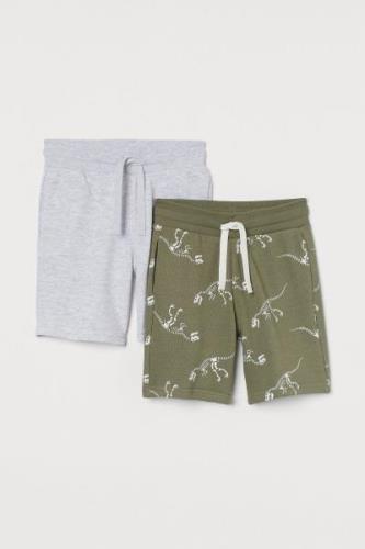 H&M 2er-Pack Sweatshorts Khakigrün/Dinosaurierskelette in Größe 92. Fa...